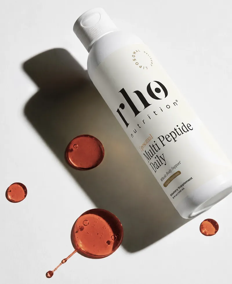 A Rho Nutrition Liposomal Multi Peptide Daily bottle with drops of the liquid